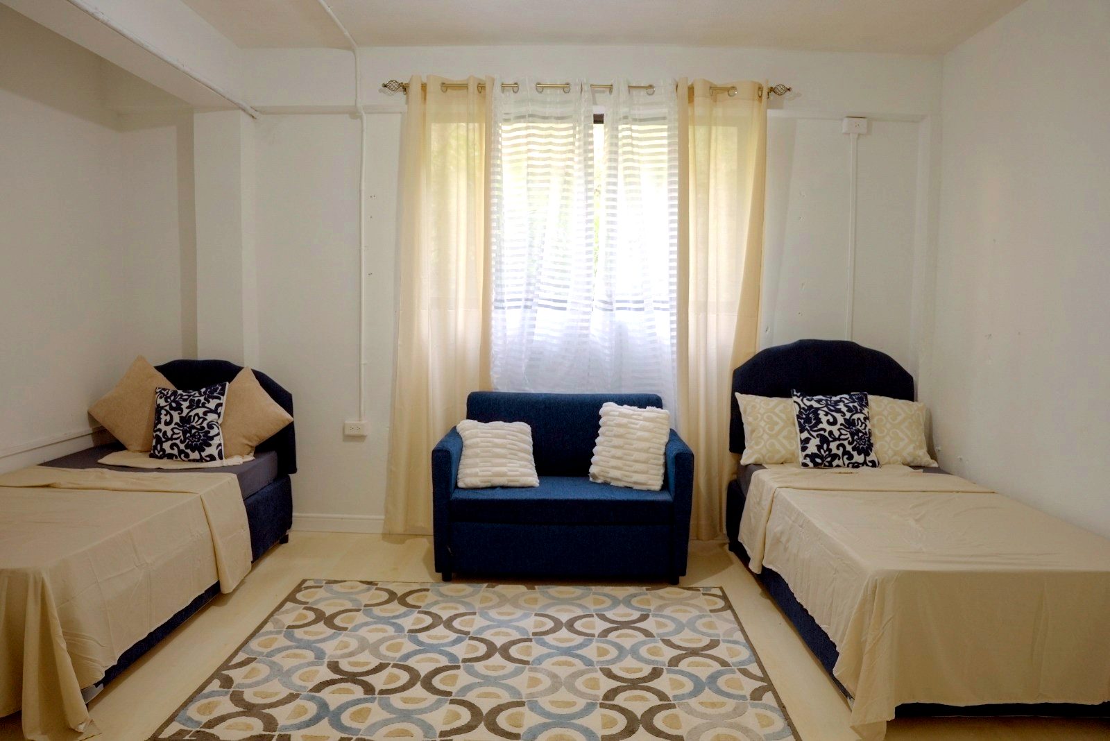 A comfortable, softly furnished shared room at Juniper House